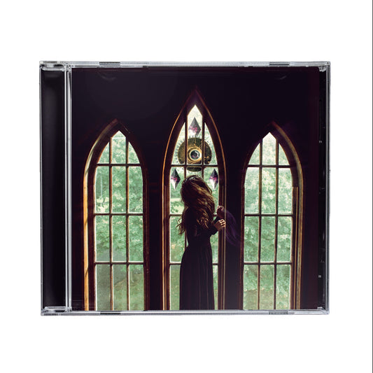 Falling Up Self Titled CD album cover with a silhouette of a person in front of gothic windows in a cathedral. There is a strange alien machine outside the window looking at the woman.